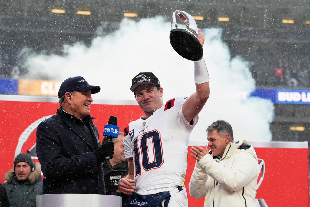 New England Patriots quarterback Drake Maye celebrates with the trophy after the AFC Championship NFL football game between the Denver Broncos and the New England Patriots, Sunday, Jan. 25, 2026, in Denver. (AP Photo/John Locher)