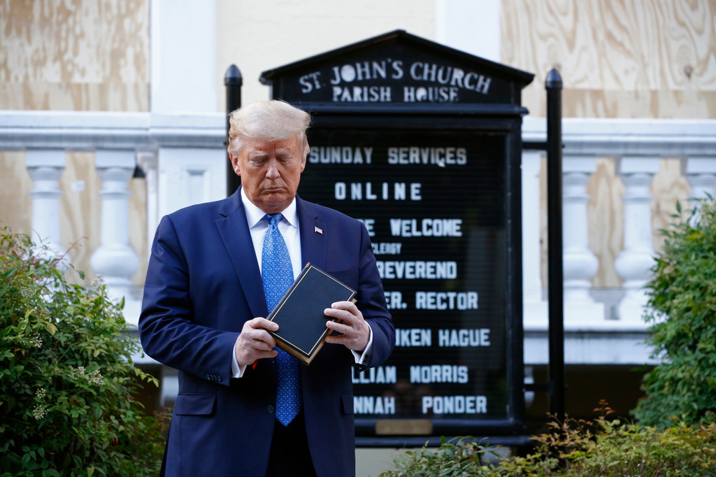 FILE - President Donald Trump holds a Bible as he stands outside St. John's Church, across Lafayette Park from the White House, on June 1, 2020, in Washington. (AP Photo/Patrick Semansky, File)
