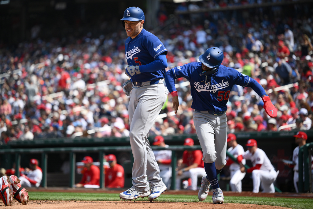 Los Angeles Dodgers' Freddie Freeman celebrates his two-run home run with Mookie Betts (50) during the fifth inning of a baseball game against the Washington Nationals, Friday, April 3, 2026, in Washington. (AP Photo/Nick Wass)