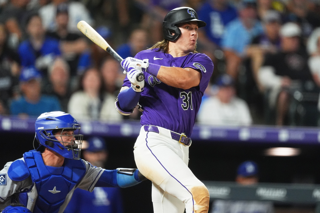 Colorado Rockies' Jake McCarthy doubles off Los Angeles Dodgers relief pitcher Tanner Scott in the ninth inning of a baseball game Tuesday, Aug. 18, 2026, in Denver. (AP Photo/David Zalubowski)