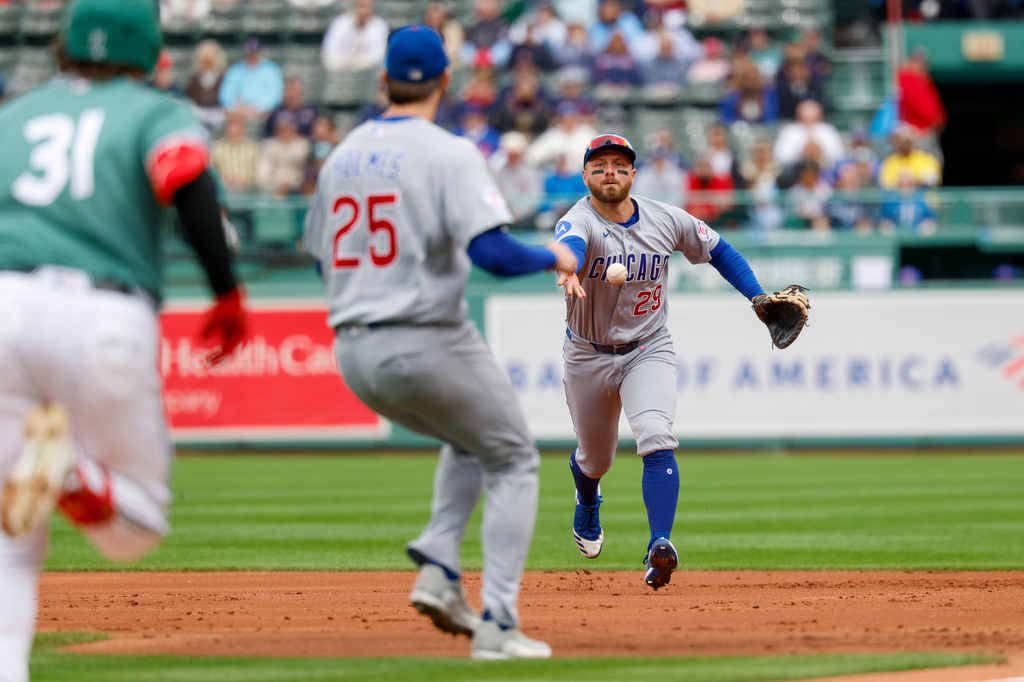 Chicago Cubs infielder Michael Busch flips a ground ball hit by Boston Red Sox' Adley Rutschman to pitcher Clay Holmes for an out during the first inning in the the first baseball game of a doubleheader, Friday, Sept. 25, 2026, in Boston. (AP Photo/Greg M. Cooper)