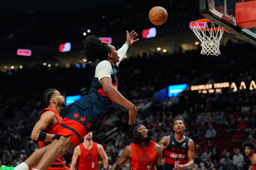 Washington Wizards guard Bub Carrington dives while going to the basket during the first half of an NBA basketball game against the Portland Trail Blazers, Sunday, March 29, 2026, in Portland, Ore. (AP Photo/Jenny Kane)