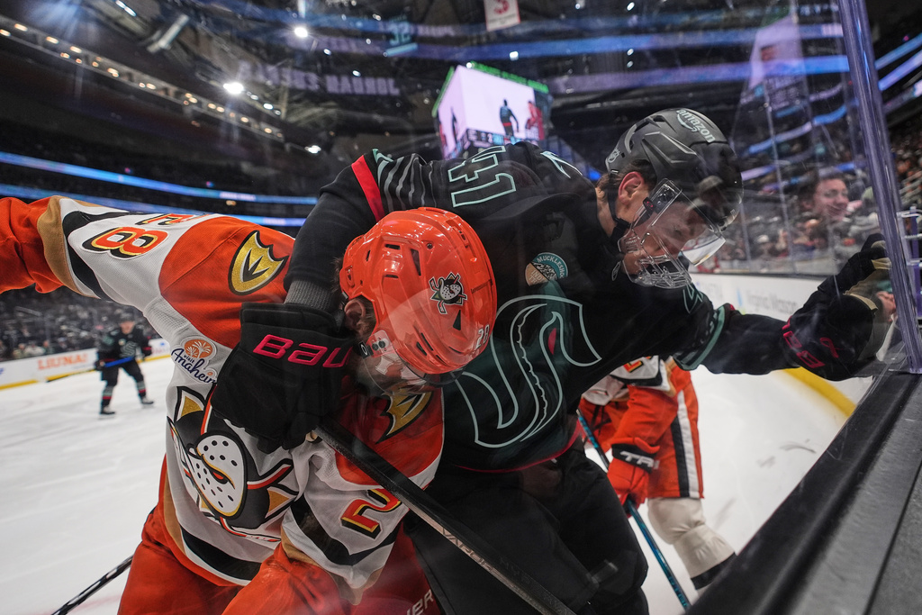 Anaheim Ducks left wing Jeffrey Viel, left, vies for the puck against Seattle Kraken defenseman Ryker Evans, right, against the boards during the second period of an NHL hockey game Friday, Jan. 23, 2026, in Seattle. (AP Photo/Lindsey Wasson)