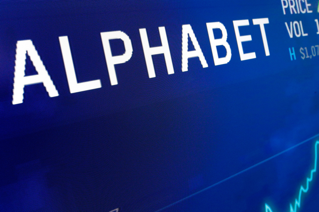 FILE - The logo for Alphabet appears on a screen at the Nasdaq MarketSite in New York, Feb. 14, 2018. (AP Photo/Richard Drew, File)