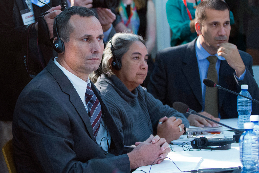 FILE - Cuban dissident Jose Daniel Ferrer, left, sits with Cuban LGBT activist Juana Mora Cedeno, center, and Cuban political activist Antonio Rodiles, right, during a meeting with President Barack Obama at the U.S. embassy in Havana, Cuba, March 22, 2016. (AP Photo/Pablo Martinez Monsivais, File)