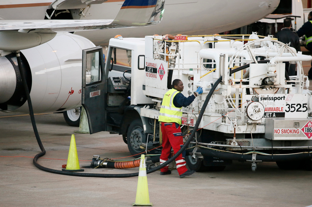 FILE - A worker prepares to fuel a United Express aircraft after it arrived at a gate at Dallas-Fort Worth International Airport, Thursday, Jan. 15, 2015, in Grapevine, Texas. (AP Photo/Tony Gutierrez, File)