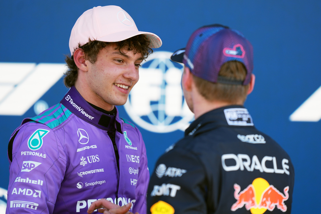 Mercedes driver Kimi Antonelli of Italy talks with Red Bull driver Max Verstappen of the Netherlands after a qualifying session for the Miami Formula One Grand Prix auto race, Saturday, May 2, 2026, in Miami Gardens, Fla. (AP Photo/Rebecca Blackwell)
