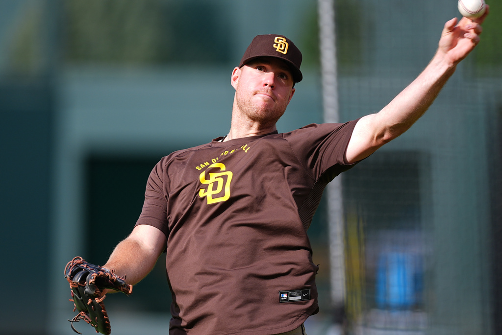 San Diego Padres first baseman Gavin Sheets warms up before a baseball game against the Colorado Rockies Tuesday, April 21, 2026, in Denver. (AP Photo/David Zalubowski)