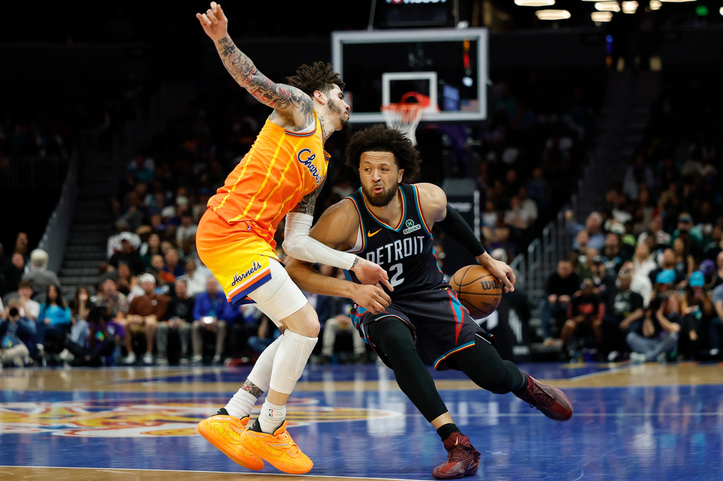 Detroit Pistons guard Cade Cunningham (2) drives against Charlotte Hornets guard LaMelo Ball during the first half of an NBA basketball game in Charlotte, N.C., Friday, April 10, 2026. (AP Photo/Nell Redmond)
