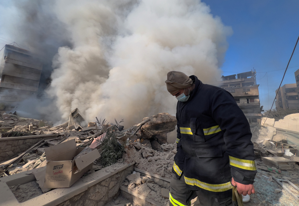 A rescue worker checks the site where several buildings were hit by Israeli airstrikes in Dahiyeh, a southern suburb of Beirut, Lebanon, Tuesday, March 3, 2026. (AP Photo/Hussein Malla)