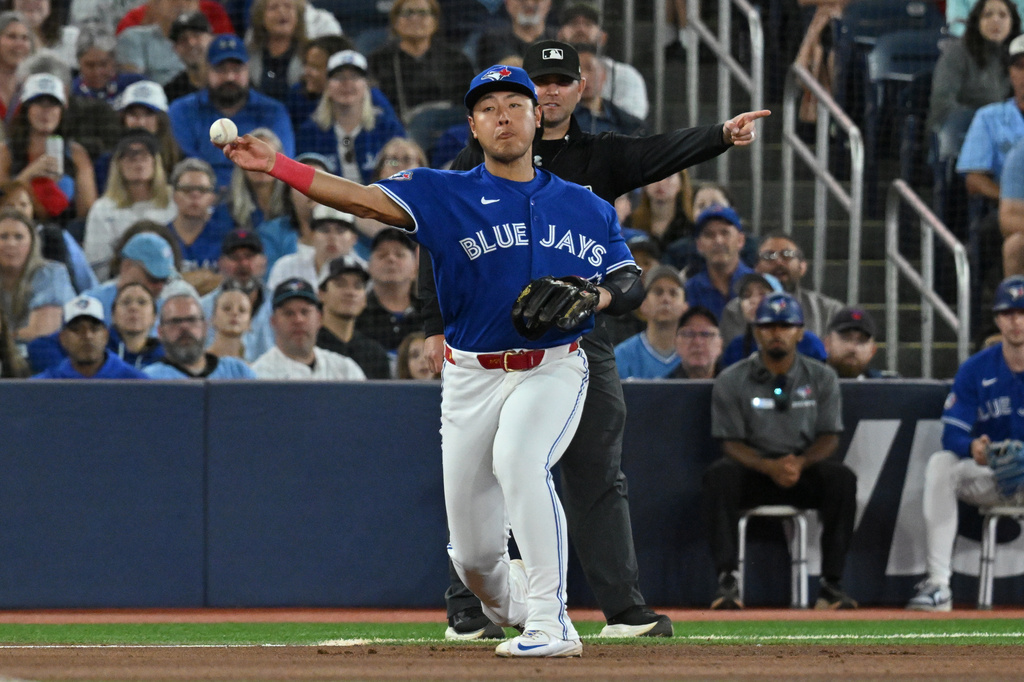 Toronto Blue Jays infielder Kazuma Okamoto (7) throws to first base to put out Detroit Tigers' Dillon Dingler during the fifth inning of a baseball game in Toronto on Monday, Sept. 14, 2026. (Jon Blacker/The Canadian Press via AP)