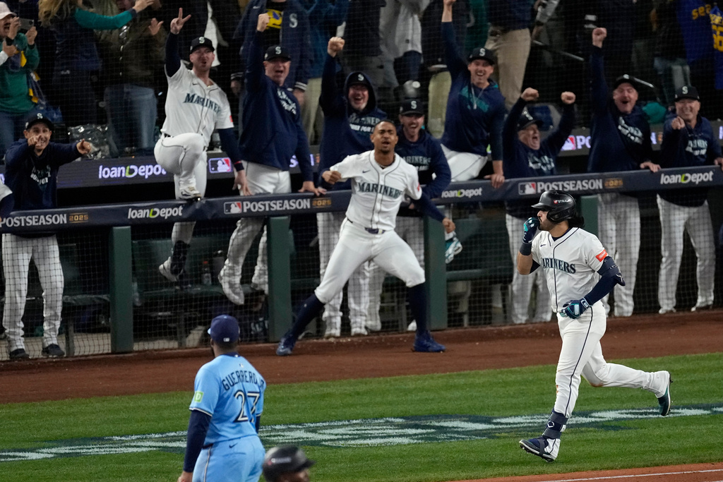 Seattle Mariners' Eugenio Suárez celebrates after hitting a grand slam home run during the eighth inning in Game 5 of baseball's American League Championship Series against the Toronto Blue Jays, Friday, Oct. 17, 2025, in Seattle. (AP Photo/David J. Phillip)