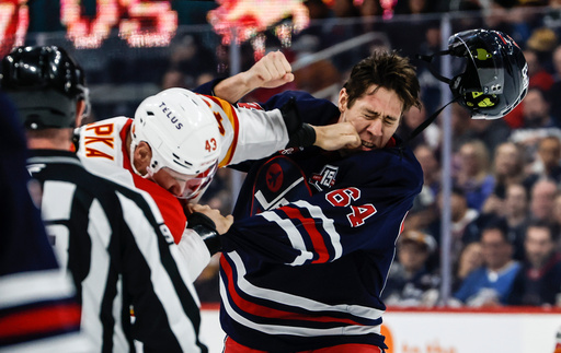 Winnipeg Jets' Logan Stanley (right) and Calgary Flames' Adam Klapka (43) fight during first period NHL action in Winnipeg on Friday, Oct. 24, 2025. (John Woods/The Canadian Press via AP) Winnipeg Jets' Logan Stanley (right) and Calgary Flames' Adam Klapka (43) fight during first period NHL action in Winnipeg on Friday, Oct. 24, 2025. (John Woods/The Canadian Press via AP)