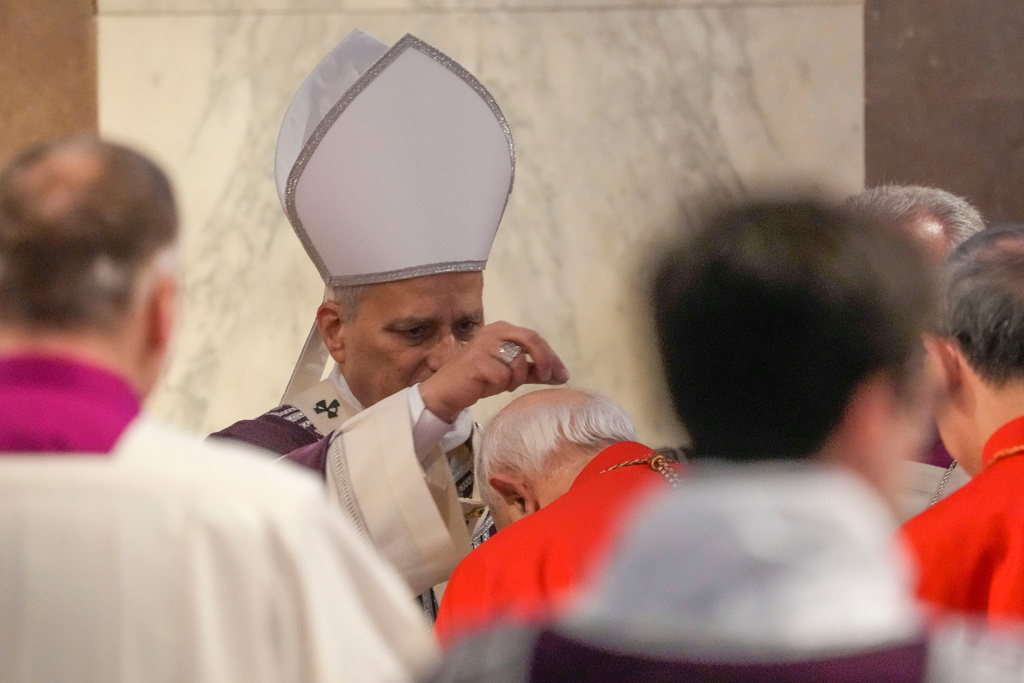 Pope Leo XIV administers the ashes during Ash Wednesday Mass, marking the start of Catholic Lent, inside the Basilica of Santa Sabina in Rome, Wednesday, Feb. 18, 2026. (AP Photo/Gregorio Borgia)