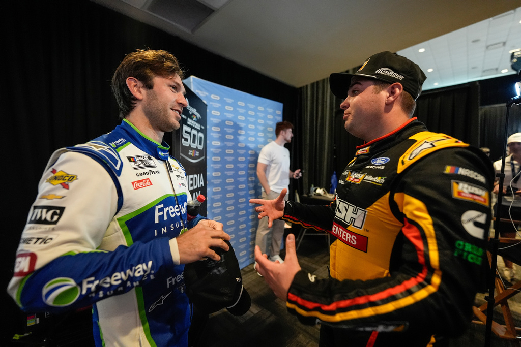 Corey LaJoie and Noah Gragson, from left, speak during a NASCAR Daytona 500 media day, Wednesday, Feb. 11, 2026, in Daytona, Fla. (AP Photo/Mike Stewart)