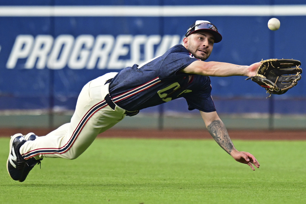 Cleveland Guardians right fielder CJ Kayfus dives to catch a ball hit by Atlanta Braves' Nacho Alvarez Jr. during the third inning of a baseball game, Friday, Aug. 15, 2025, in Cleveland. (AP Photo/David Dermer)