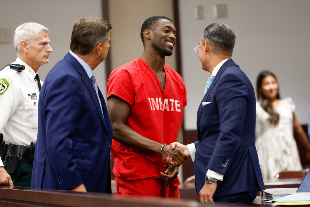 Terrion Arnold, a Detroit Lions cornerback, shakes hands with his attorneys R. Timothy Jansen, left, and A.J. Alvarez, during the conclusion of his pretrial detention hearing at the Hillsborough County Courthouse on Monday, June 29, 2026, in Tampa, Fla. (Jefferee Woo/Tampa Bay Times via AP)