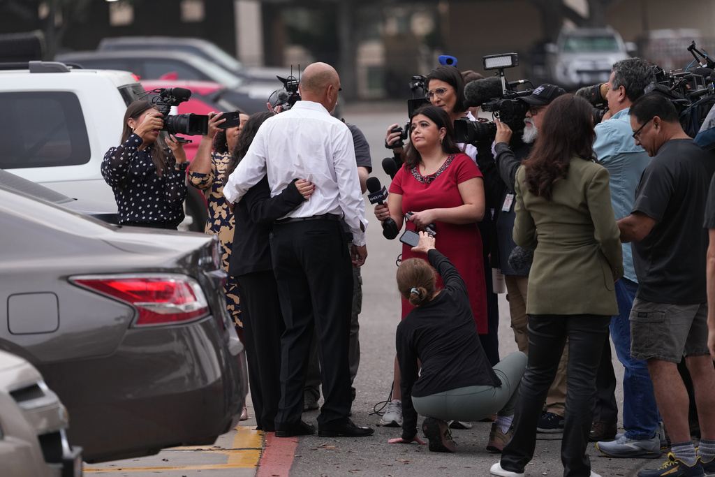 Family member Jesse Rizo, center, talks to the media before the trial for former Uvalde school district police officer Adrian Gonzales at the Nueces County Courthouse in Corpus Christi, Texas, Tuesday, Jan. 6, 2026. (AP Photo/Eric Gay)