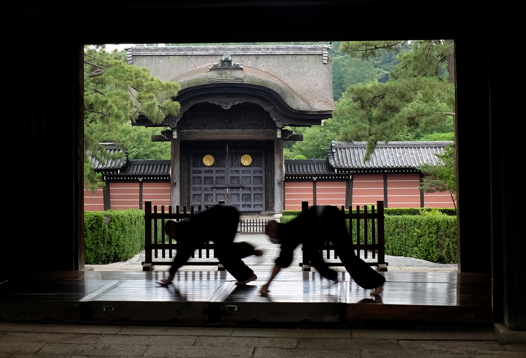 FILE - Monks polish the wooden corridor of the walkway that connects between temple buildings at Soji-ji in Yokohama, Japan on July 5, 2016. (AP Photo/Kiichiro Sato, File)