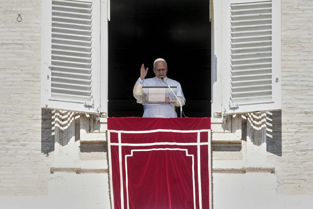 Pope Leo XIV delivers his speech as he recites the Angelus noon prayer from the window of his studio overlooking St.Peter's Square, at the Vatican, Sunday, Sept. 21, 2025. (AP Photo/Andrew Medichini)