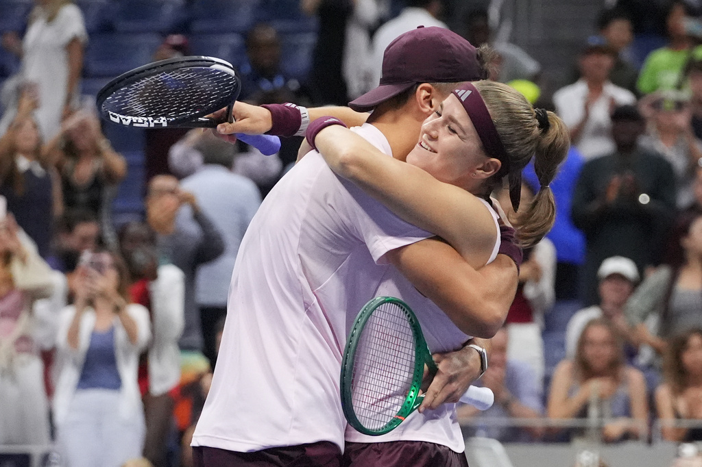 Jakub Mensik, of the Czech Republic, celebrates with Karolina Muchova, right, of the Czech Republic, after they won the mixed doubles final match against Belinda Bencic, of Switzerland, and Flavio Cobolli, of Italy, at the U.S. Open tennis championships Wednesday, Aug. 26, 2026, in New York. (AP Photo/Frank Franklin II)