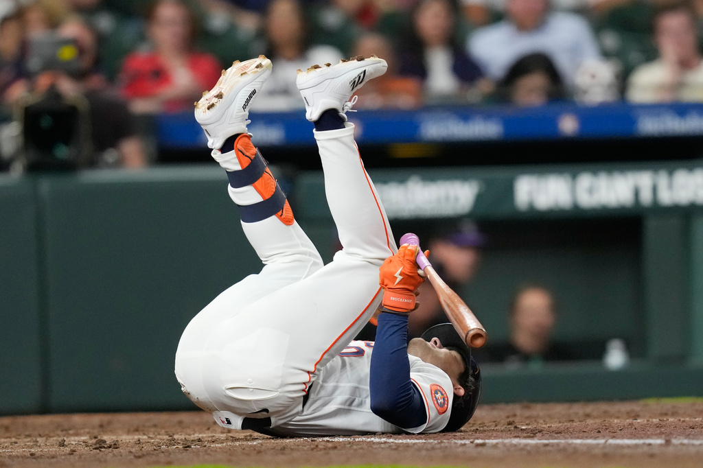 Houston Astros' Joey Loperfido falls after being hit by a pitch thrown by Colorado Rockies pitcher Chase Dollander during the fourth inning of a baseball game Thursday, April 16, 2026, in Houston. (AP Photo/David J. Phillip)