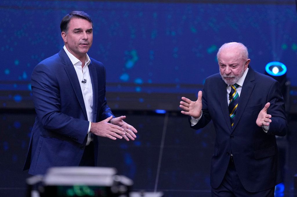 FILE - Brazil President Luiz Inacio Lula da Silva, right, who is running for reelection, gestures as opposition presidential candidate Sen. Flavio Bolsonaro stands beside him during a televised presidential debate one week before the runoff election in Sao Paulo, Brazil, Oct. 18, 2026. (AP Photo/Andre Penner, File)