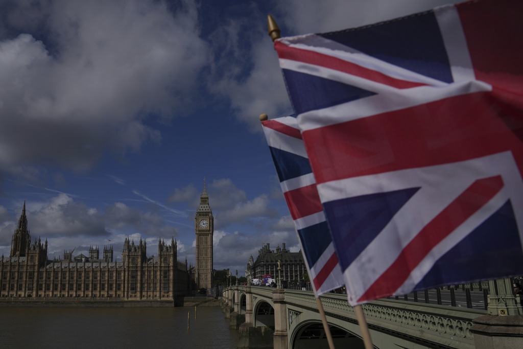 Union flag is seen in front of the House of Parliament in London, Monday, Sept. 1, 2025. (AP Photo/Kin Cheung)