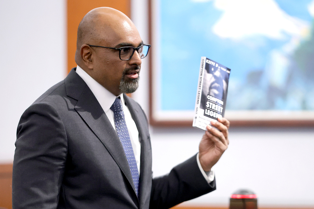 Chief Deputy District Attorney Binu Palal holds a copy of Duane Davis' book "Compton Street Legends" during closing arguments in the Duane Davis murder trial, related to the 1996 killing of rapper Tupac Shakur, in Clark County District Court at the Regional Justice Center in Las Vegas, Monday, Aug. 31, 2026. (Steve Marcus/Pool Photo via AP)