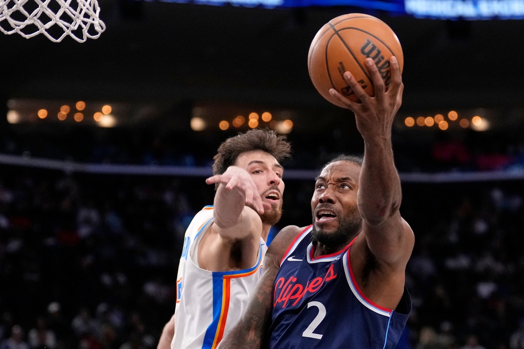 Los Angeles Clippers forward Kawhi Leonard, right, shoots as Oklahoma City Thunder center Chet Holmgren defends during the second half of an NBA basketball game Wednesday, April 8, 2026, in Inglewood, Calif. (AP Photo/Mark J. Terrill)