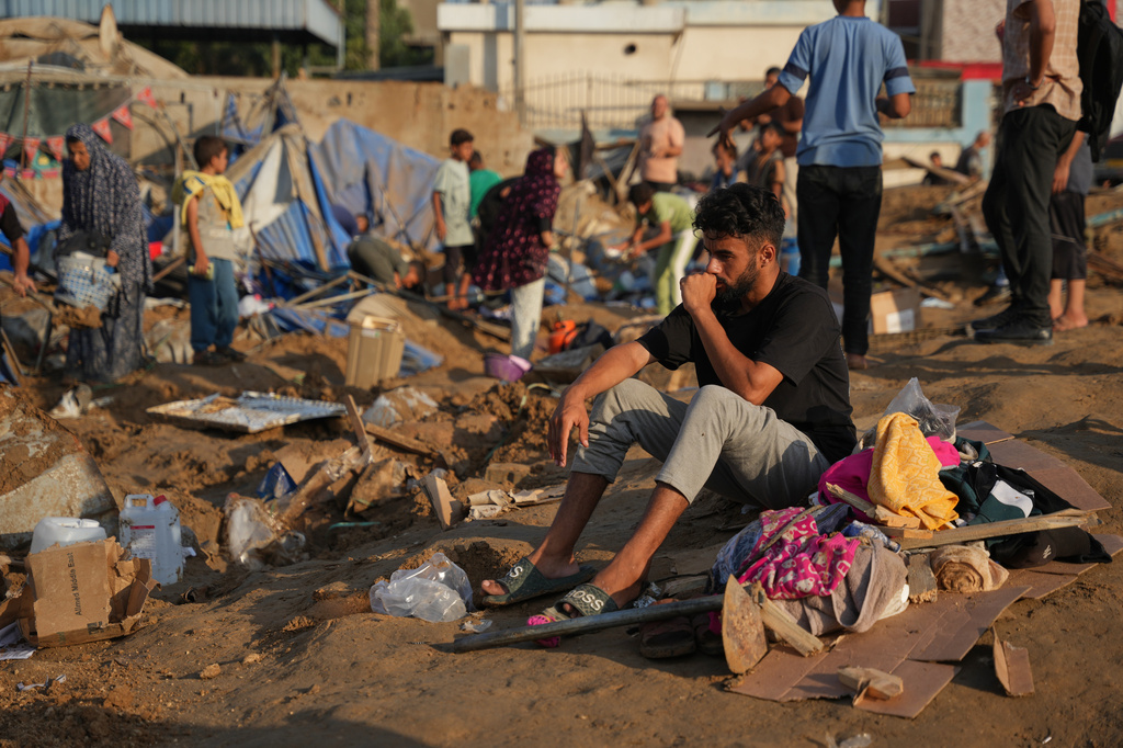 Palestinians inspect the scene of an Israeli airstrike near al-Aqsa Hospital in Deir al-Balah in the central Gaza Strip, Saturday, Aug. 1, 2026. (AP Photo/Abdel Kareem Hana)
