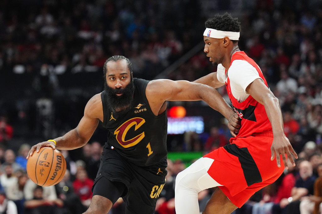 Cleveland Cavaliers guard James Harden (1) tries to move around Toronto Raptors guard Ja'kobe Walter, right, during the first half of Game 4 in a first-round NBA basketball playoffs series in Toronto, Sunday, April 26, 2026. (Frank Gunn/The Canadian Press via AP)