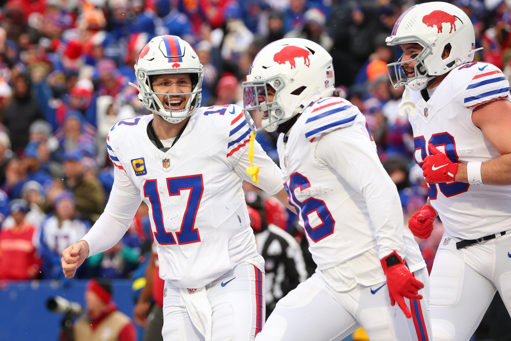 Buffalo Bills quarterback Josh Allen (17) celebrates with tight end Dawson Knox, right, after a touchdown by running back Ty Johnson, center, against the Tampa Bay Buccaneers during the first half of an NFL football game, Sunday, Nov. 16, 2025, in Orchard Park, N.Y. (AP Photo/Jeffrey T. Barnes)