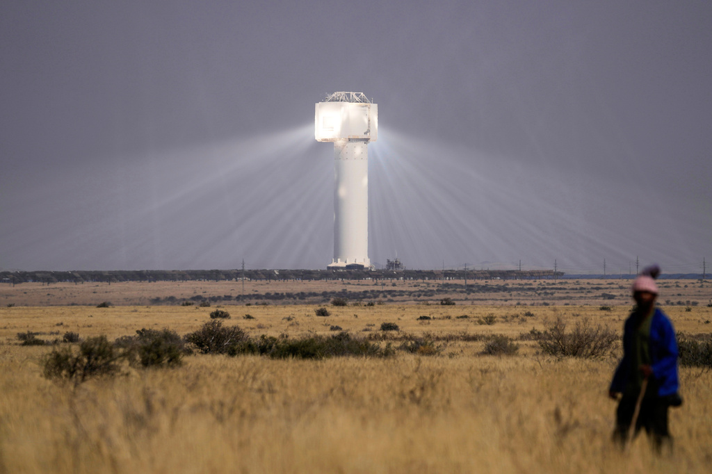 FILE - A shepherd watches livestock near Khi Solar One, a solar thermal plant that converts the sun's light energy into electricity, outside Upington, South Africa, in the Northern Cape province, Aug. 29, 2025. (AP Photo/Themba Hadebe, File)