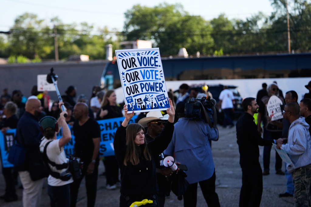People protesting against Louisiana Governor Jeff Landry gather outside Orleans Parish criminal court on the day Calvin Duncan, an exoneree who was elected Orleans Parish clerk of criminal court, took his first day in office, Monday, May 4, 2026, in New Orleans. (AP Photo/Gerald Herbert)