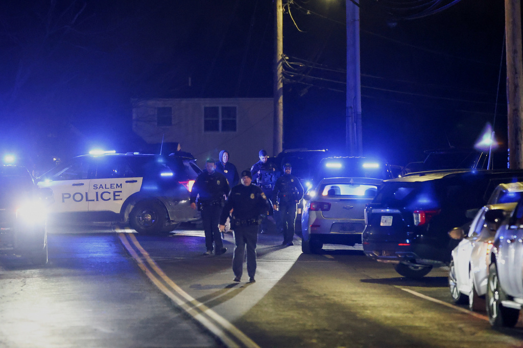 Law enforcement officers search the area for the Brown University shooting suspect, Thursday, Dec. 18, 2025, in Salem, N.H. (AP Photo/Reba Saldanha)