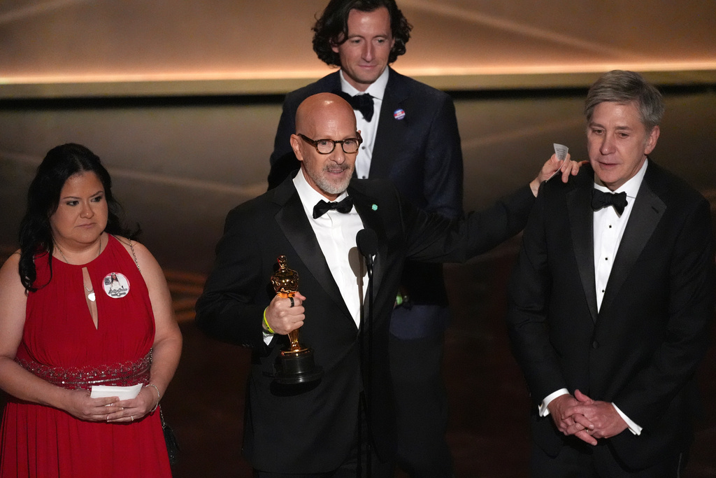Gloria Cazares, from left, Joshua Seftel, Conall Jones, and Steve Hartman accept the award for documentary short film for "All the Empty Rooms" during the Oscars on Sunday, March 15, 2026, at the Dolby Theatre in Los Angeles. (AP Photo/Chris Pizzello)