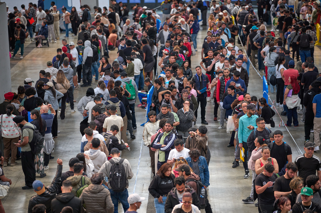 FILE - Migrants queue at a public service office to obtain paperwork needed to apply for Spain's immigration amnesty, in L'Hospitalet de Llobregat near Barcelona, Spain, on April 21, 2026. (AP Photo/Emilio Morenatti, File)
