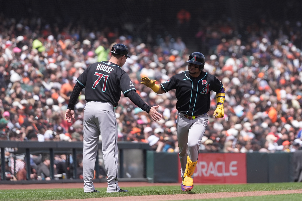 Arizona Diamondbacks' Gabriel Moreno, right, is congratulated by third base coach J.R. House (71) after hitting a home run against the San Francisco Giants during the third inning of a baseball game Monday, May 25, 2026, in San Francisco. (AP Photo/Jeff Chiu)