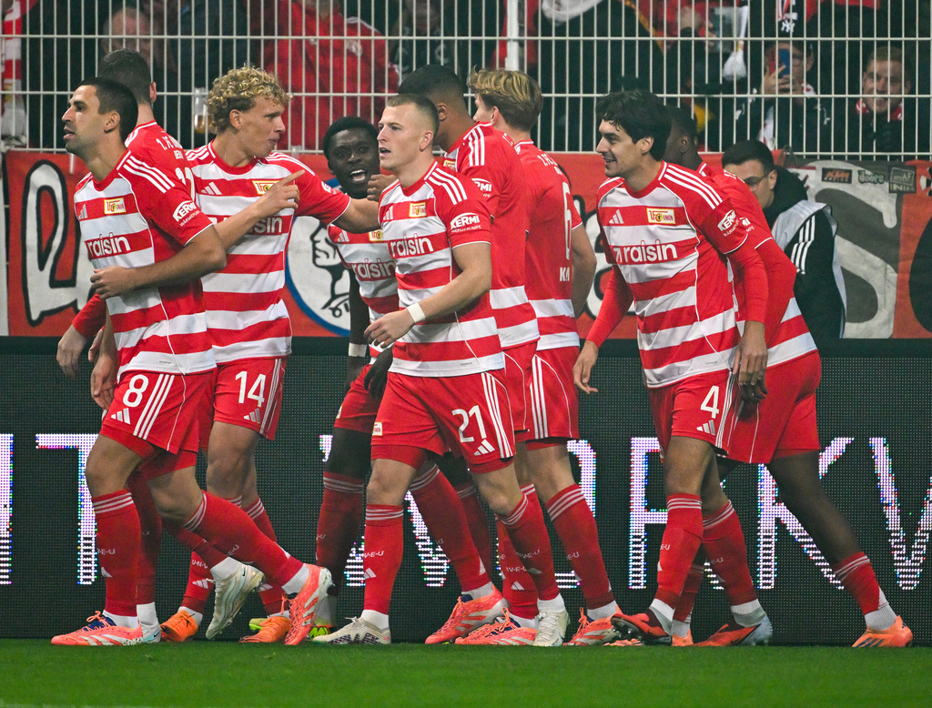 Union players celebrate after their first goal during the German Bundesliga soccer match between 1. FC Union Berlin and Borussia Moenchengladbach in Berlin, Friday, Oct. 17, 2025. (Soeren Stache/dpa via AP)