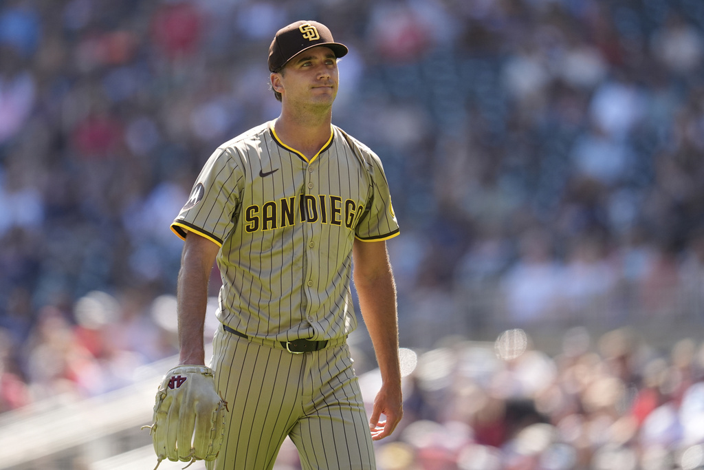 San Diego Padres relief pitcher Kyle Hart walks back to the dugout after completing the bottom of the third inning of a baseball game against the Minnesota Twins, Sunday, Aug. 31, 2025, in Minneapolis. (AP Photo/Abbie Parr)