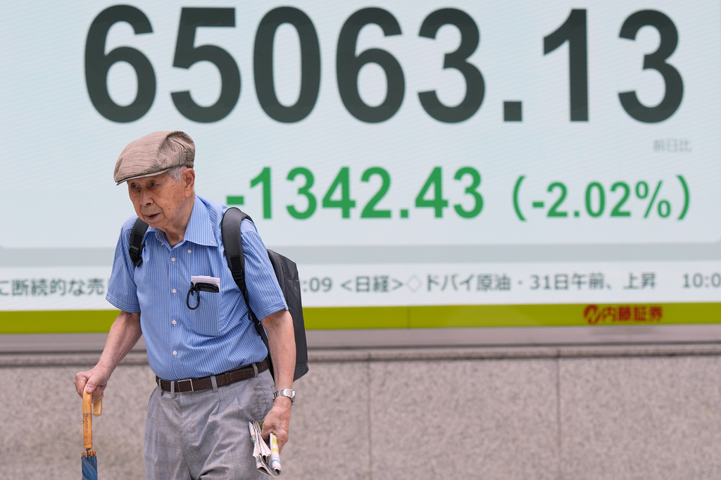 A person walks in front of an electronic stock board showing Japan's Nikkei index at a securities firm Monday, Aug. 31, 2026, in Tokyo. (AP Photo/Eugene Hoshiko)