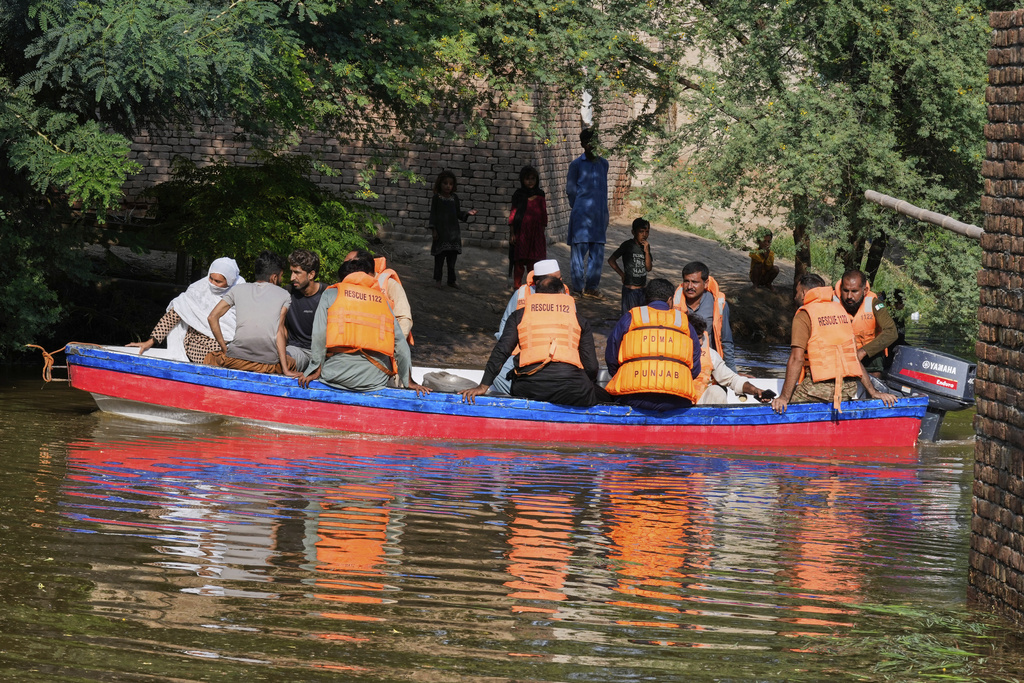 Rescue workers evacuate villagers from a flooded area in Muza Islam Wala, in Jhang district, Pakistan, Tuesday, Sept. 2, 2025. (AP Photo/K.M. Chaudary)