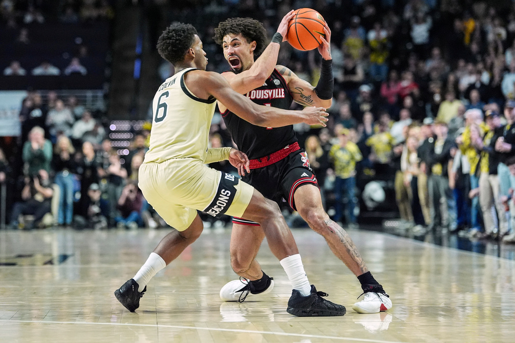 Louisville guard J'vonne Hadley (1) is defended by Wake Forest guard Myles Colvin (6) during the second half of an NCAA college basketball game, Saturday, Feb. 7, 2026, in Winston-Salem, N.C. (AP Photo/Matt Kelley)
