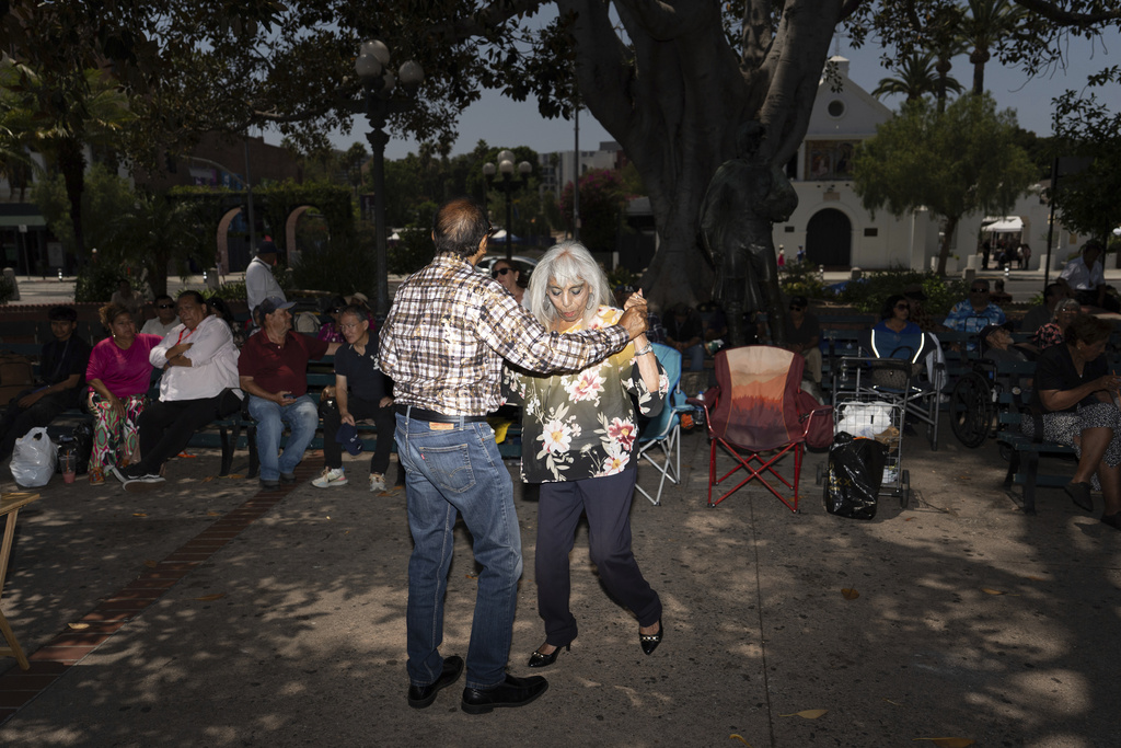 Agustin Gonzalez, left, and Carmen Beltran dance to mariachi music at Los Angeles Plaza Park in Los Angeles, Saturday, July 19, 2025, amid ongoing ICE raids. (AP Photo/Jae C. Hong)