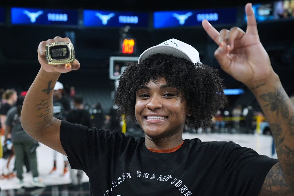 Texas guard Rori Harmon holds her MVP trophy as she and teammates celebrate their win over South Carolina in an NCAA college basketball game in the Players Era tournament in Las Vegas, Thursday, Nov. 27, 2025. (AP Photo/Eric Gay)