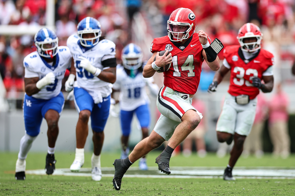 Georgia quarterback Gunner Stockton (14) runs with the ball during the first half of an NCAA college football game against Kentucky, Saturday, Oct. 4, 2025, in Athens, Ga. (AP Photo/Colin Hubbard)