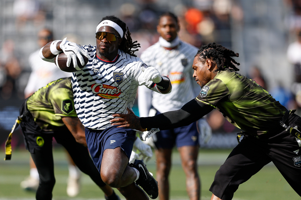 FILE - Founders FFC's Ashton Jeanty has his flag pulled by Wildcats FFC's Jalen Ramsey during the Fanatics Flag Football Classic, Saturday, March 21, 2026, in Los Angeles. (AP Photo/Caroline Brehman, File)