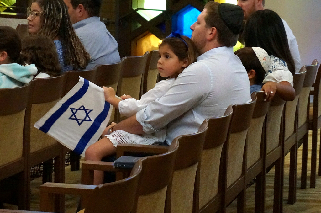 FILE - A family with Israel flags attends Shabbat services at Temple Beth Sholom in Miami Beach, Fla., Oct. 13, 2023. (AP Photo/Giovanna Dell'Orto, File)