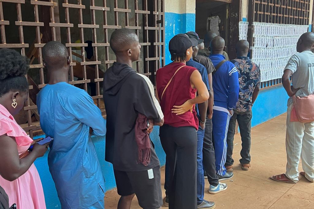 Voters queue at a polling station to cast their ballot in the presidential election in Bangui, Central African Republic, Sunday, Dec. 28, 2025. (AP Photo/Jean-Fernand Koena)